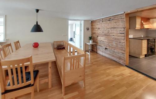 a kitchen and dining room with a wooden table and chairs at Amazing Home In Ör With Wifi in Ör