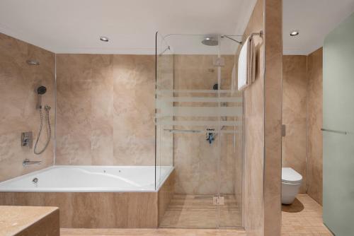 a bathroom with a bath tub and a toilet at Hilton Istanbul Bosphorus in Istanbul
