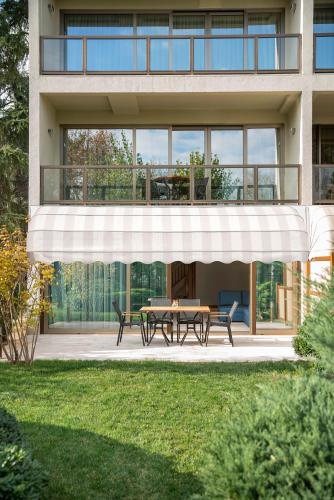 a house with a table and benches in front of it at Hilton Istanbul Bosphorus in Istanbul