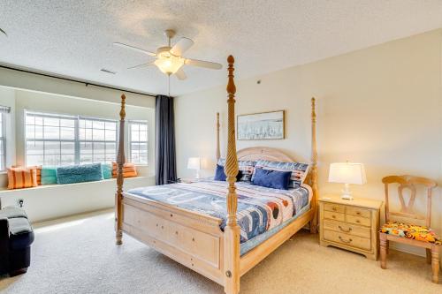 a bedroom with a bed and a ceiling fan at Waterfront Condo with Pool on Lake of the Ozarks in Lake Ozark