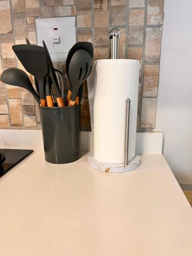 a roll of paper towels and a container of utensils at Exquisite Classy 1 bed in Midrand at 93 on New Lifestyle Estate in Midrand