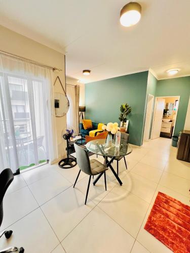 a living room with a glass table and a couch at Exquisite Classy 1 bed in Midrand at 93 on New Lifestyle Estate in Midrand