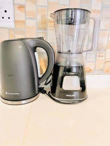 a black blender sitting on top of a counter at Exquisite Classy 1 bed in Midrand at 93 on New Lifestyle Estate in Midrand