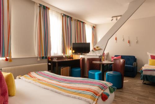 Ένα ή περισσότερα κρεβάτια σε δωμάτιο στο Hôtel de la Plage