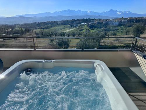 a bath tub filled with water on a balcony at Cataleya Resort & Spa in Notaresco