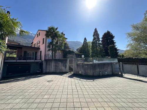 a house with a fence in front of a driveway at VILLA GINEVRA COLICO - Swimming Pool WITH LAKE COMO VIEW in Colico