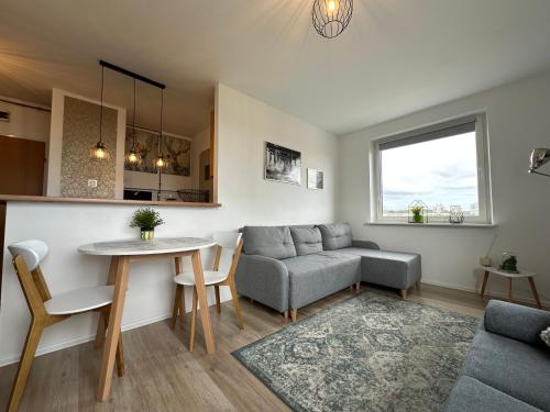 a living room with a couch and a table at Panorama Bałtyku in Sopot