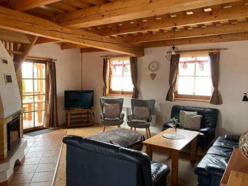 a living room with couches and a tv at Chalupa na Liptove - Chata pri Mare in Liptovský Trnovec