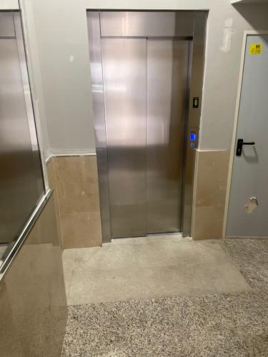 a elevator in a building with a metal door at Apartamento Paula in Valladolid