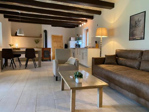 a living room with a couch and a table at Villa Lano in Kispeterd