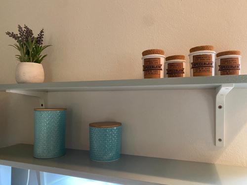 a shelf with bowls and cups on it at Villa Lano in Kispeterd