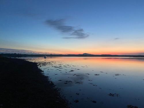 a large body of water at sunset with the sky at Pinecones in Valley