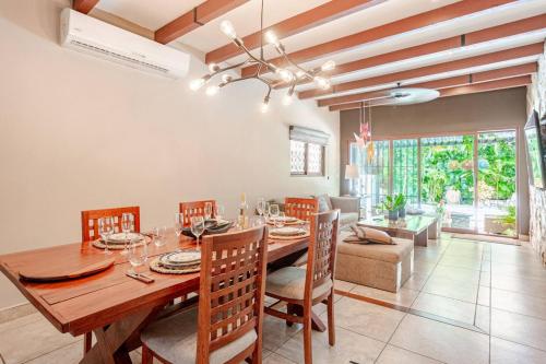 a dining room with a wooden table and chairs at Exclusive Beach Residence! with Private Pool in Playa del Carmen