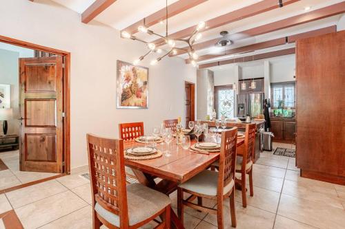 a dining room with a wooden table and chairs at Exclusive Beach Residence! with Private Pool in Playa del Carmen