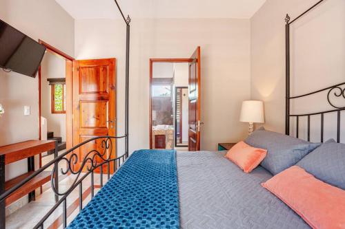 a bedroom with a bed and a balcony with a television at Exclusive Beach Residence! with Private Pool in Playa del Carmen