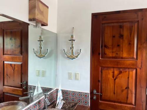 a bathroom with anchors on the wall next to a door at Exclusive Beach Residence! with Private Pool in Playa del Carmen