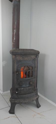 an old wood stove sitting on a floor at Domek Chrzanówka in Kudowa-Zdrój