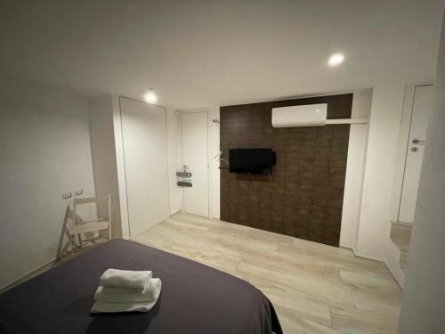 a bedroom with a bed with two towels on it at Carlotta Rooms in Conversano