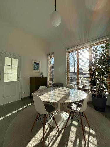 a dining room with a glass table and two chairs at Luxury apartment, private terrace & FREE PARKING in Antwerp