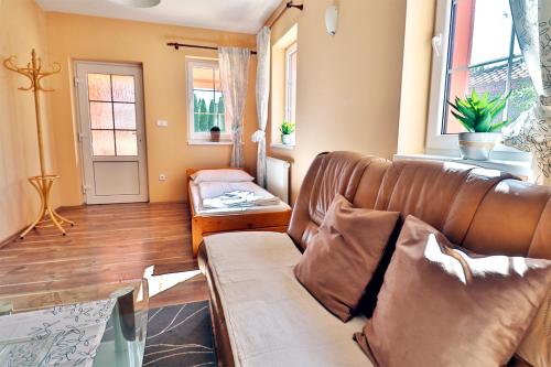 a living room with a couch and a table at Bezměrovský dvůr Kroměříž in Kroměříž