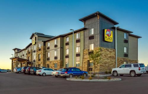 a large building with cars parked in a parking lot at My Place Hotel-Colorado Springs,CO in Colorado Springs