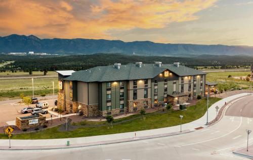 an aerial view of a building with a road and mountains at My Place Hotel-Colorado Springs,CO in Colorado Springs