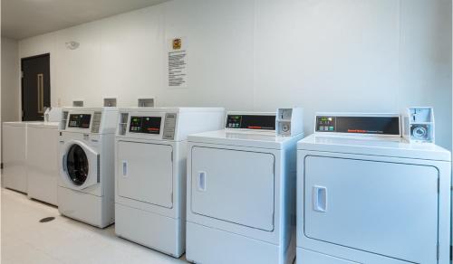 a row of washing machines in a room at My Place Hotel-Colorado Springs,CO in Colorado Springs
