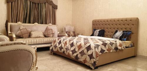a bedroom with a bed and a couch at Al Wahda Private Couples Room in Abu Dhabi
