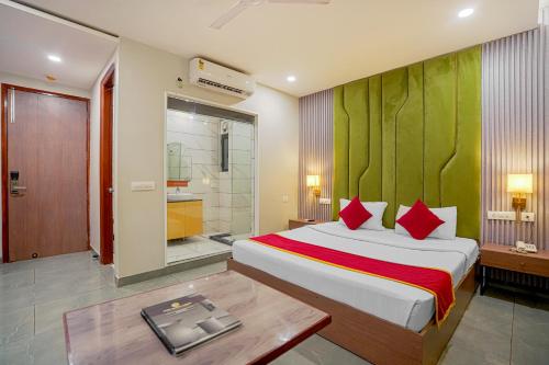 a bedroom with a large bed and a bathroom at Hotel Highway Greens Near VR Punjab Mall Airport Road Mohali Chandigarh in Mohali