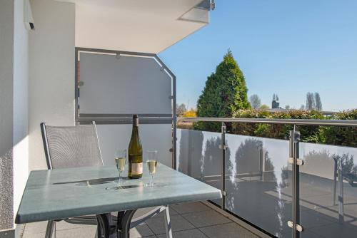 a table with two glasses of wine on a balcony at Gästehaus D i c k r e i t e r in Immenstaad am Bodensee
