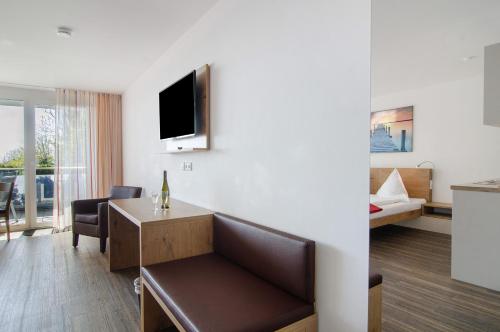 a hotel room with a couch and a bed at Gästehaus D i c k r e i t e r in Immenstaad am Bodensee