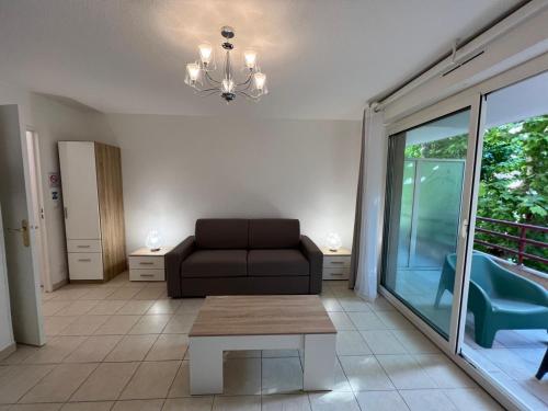 a living room with a couch and a table at Sunny studio with Terrace in Nice