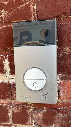 une boîte métallique sur le côté d'un mur de briques dans l'établissement Maison partagée - Studio bas, à Beauvais