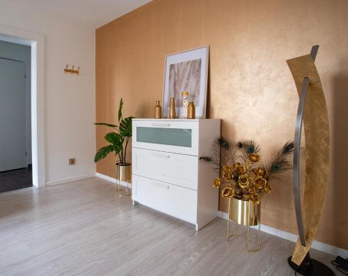 a living room with a dresser and a wall at Katowice Golden Peacock - Grazynskiego 7 in Katowice