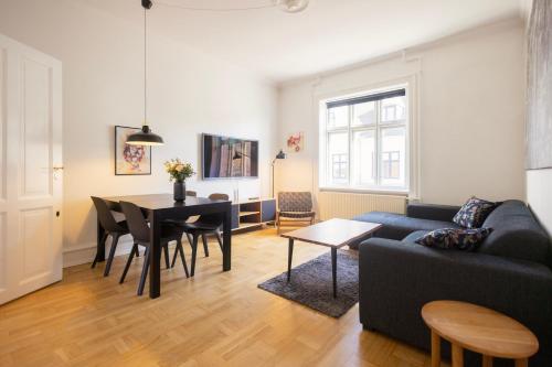a living room with a couch and a table at Central Lyngby Apartments in Kongens Lyngby