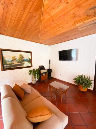 a living room with a couch and a flat screen tv at Villa Zunilda in Rivera