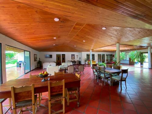 a dining room with wooden ceilings and tables and chairs at Villa Zunilda in Rivera
