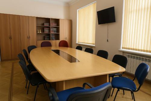a conference room with a wooden table and chairs at HeyTun Gyumri in Gyumri