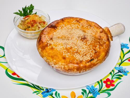a pie on a white plate with a salad at Resort EuroPark Fundata in Fundata