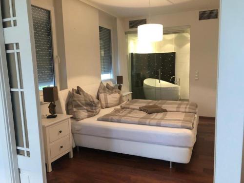 a bedroom with a bed and a mirror at Luxus Seeappartements in Velden am Wörthersee