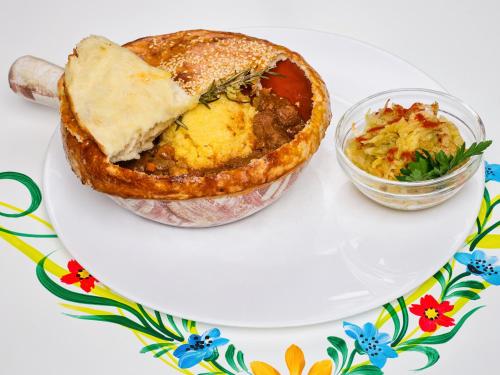 a plate with a pie and a bowl of salad at Resort EuroPark Fundata in Fundata