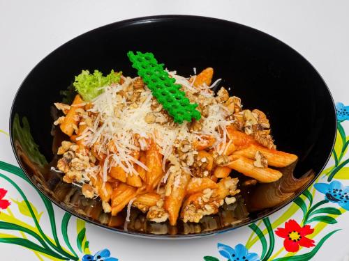 a bowl of food with pasta and cheese at Resort EuroPark Fundata in Fundata