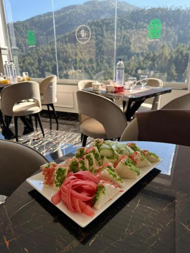 a plate of food on a table in a restaurant at Destination Resort Thandiani in Abbottabad