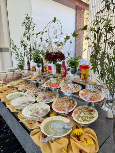 a table with many plates of food on it at Destination Resort Thandiani in Abbottabad