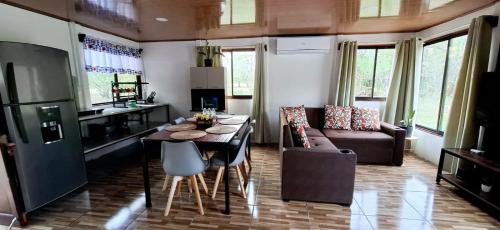 a kitchen and living room with a table and a couch at House of Dreams in Nicoya