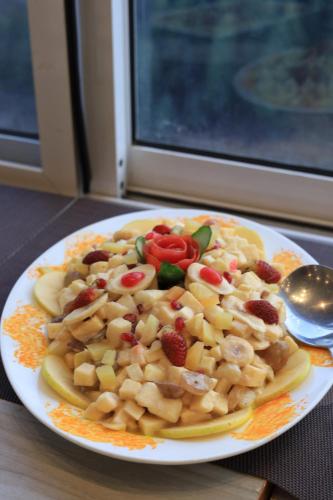 a plate of food with fruits and vegetables on a table at Destination Resort Thandiani in Abbottabad