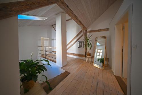 a large room with a wooden floor and a mirror at Renesanční dům in Mikulov