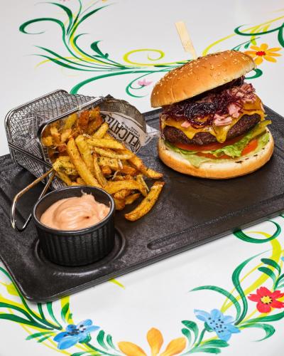 a tray with a hamburger and french fries and dip at Resort EuroPark Fundata in Fundata