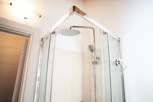 a shower in a bathroom with a glass shower stall at Dicentra Guest House in Villanova dʼAsti