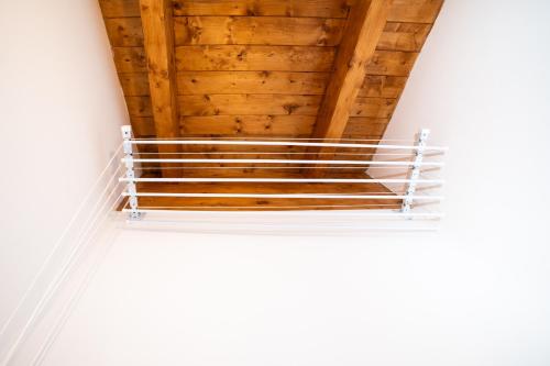 a shelf in a room with a wooden ceiling at Dicentra Guest House in Villanova dʼAsti